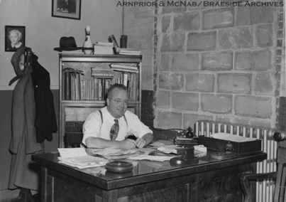 Photograph of Mayor of Arnprior, Robert M. Simpson in his office.